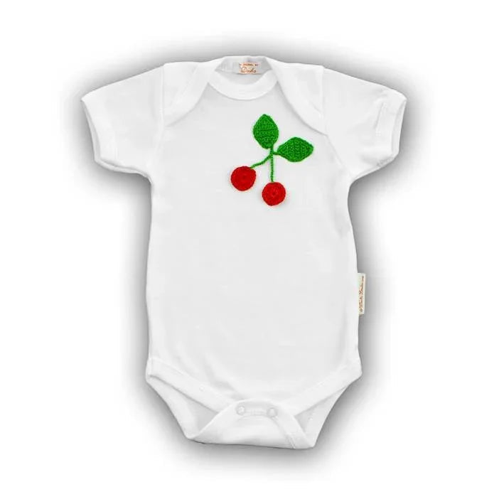White Norvella baby onesie featuring a hand-crocheted red cherry design on the chest.