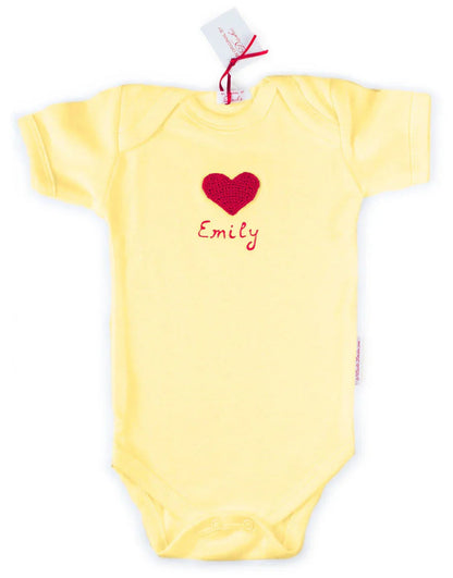 Yellow Norvella baby onesie featuring a red crocheted heart and the name Emily in 3D paint.