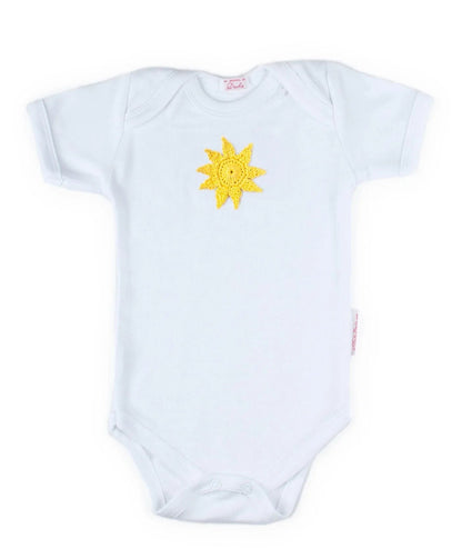 White Norvella baby onesie featuring a hand-crocheted yellow sun applique.
